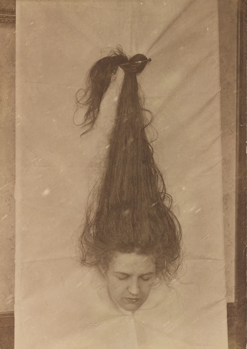 Untitled (Woman with head through sheet) by American 20th Century, photograph, 1890-1919