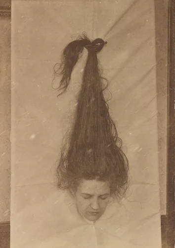 Untitled (Woman with head through sheet) by American 20th Century, photograph, 1890-1919