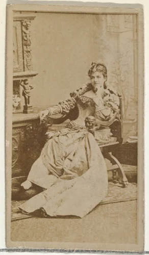 [Actress in studio reclining in heavy wooden chair], from the Actors and Actresses series (N145-8) issued by Duke Sons & Co. to promote Duke Cigarettes by W. Duke, Sons & Co., photograph, 1890-1895