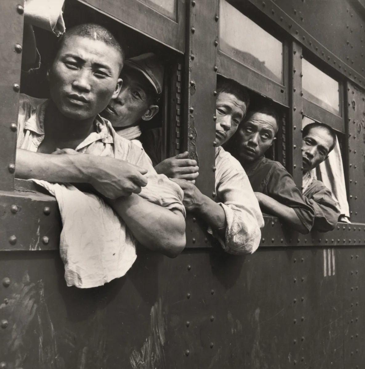 Japanese Soldiers and Civilians Crowd Trains to Tokyo at a Hiroshima Station after the Demobilization of the Japanese Military, Hiroshima, Japan by Wayne Miller, photograph, 1945