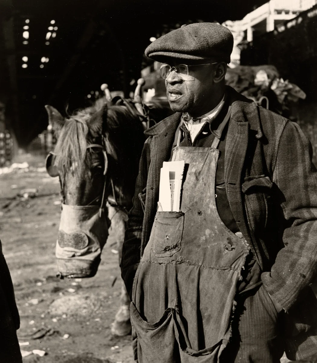 Delivery Man and Horse with Nose Bag Rest under Elevated Train Tracks, Chicago, Illinois by Wayne Miller, photograph, 1947