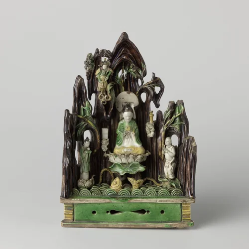Figure of Guanyin seated on a lotus flower against a rocky wall by anonymous, other, 1680-1720