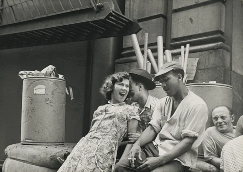 After lunch Connie jokes with other workers outside the factory. by Robert Frank, photograph, 1951